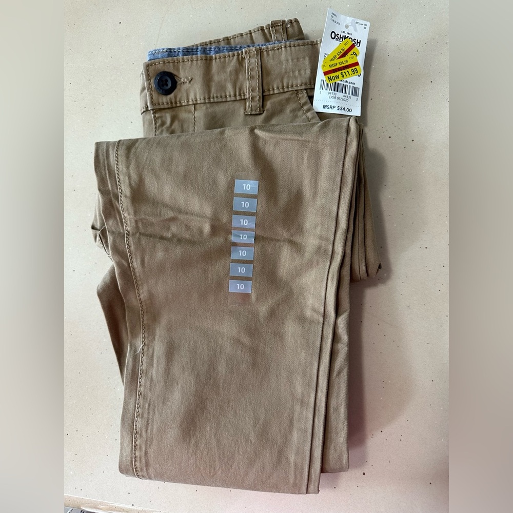 BRAND NEW Oshkosh boys tan docker pants with side and back pockets. Size 10.